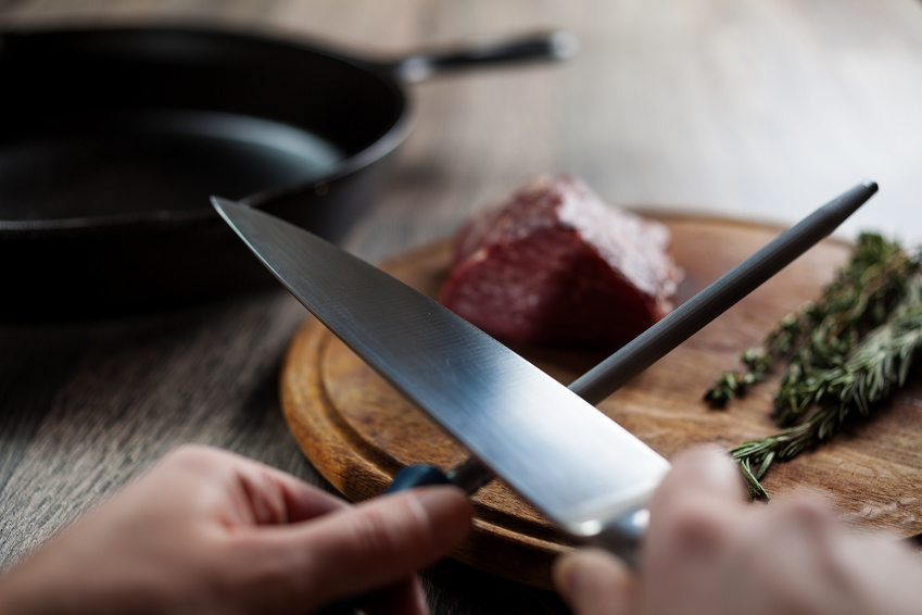 Sharpening the knife to cut the beef steak